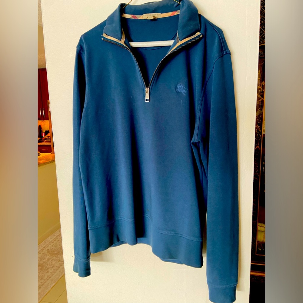 Burberry pull over in med size dark bluish green color.